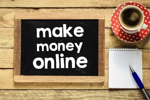 Make money online printing on a blackboard near a cup of coffee and notebook