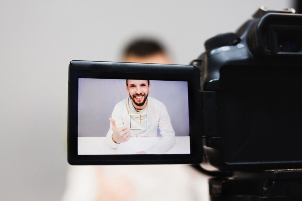 Man filming himself for online course creation.